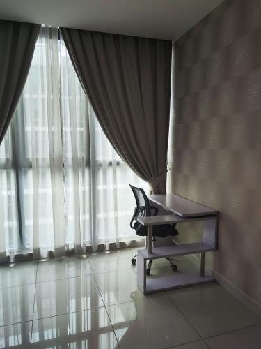 a chair sitting in a room with a window at Cozy Stay - Atria Sofo in Damansara Jaya in Petaling Jaya