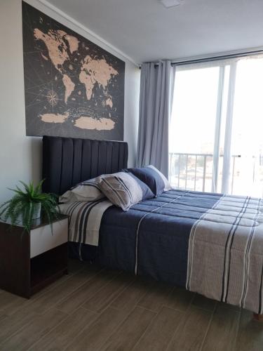 a bedroom with a bed and a large window at Movistar Conciertos y buen descanso in Santiago