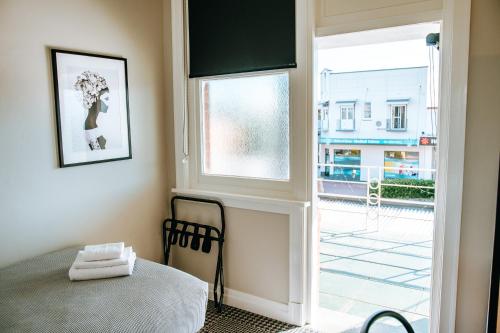 a bedroom with a bed and a large window at Tourist Hotel Narrabri in Narrabri