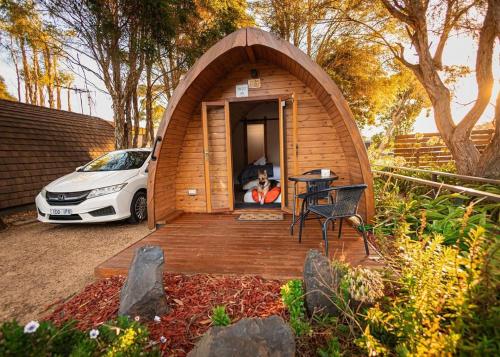 a small wooden house with a car parked in it at Wonthaggi Park Lane Holiday Park in Wonthaggi