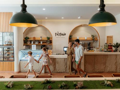 a family walking in front of a restaurant at Grand Sirenis Riviera Maya Resort & Spa All Inclusive in Akumal