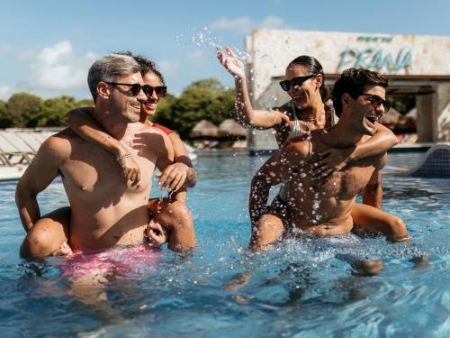 a group of men in the water at a pool at Grand Sirenis Riviera Maya Resort & Spa All Inclusive in Akumal