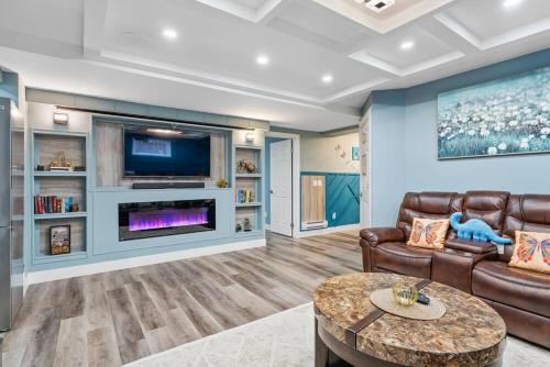 a living room with a couch and a tv at Private Family Entertainer's Suite in Calgary