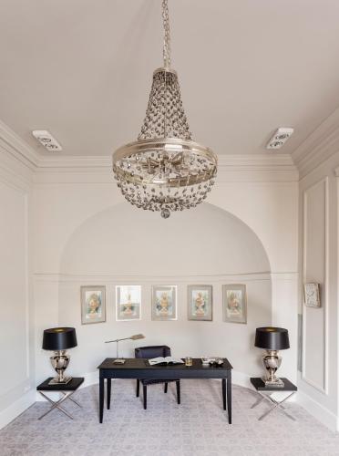 a large room with a table and a chandelier at Hotel Bellotto in Warsaw