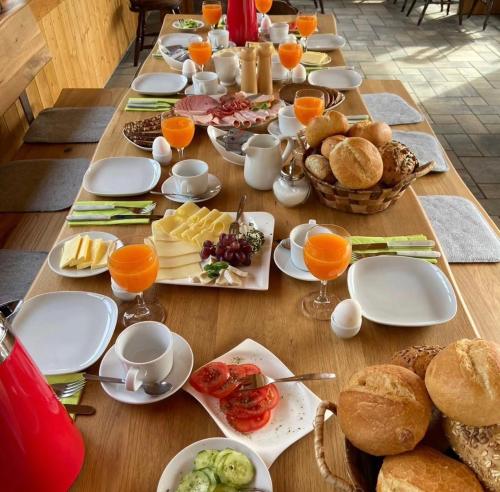 a long table with plates of food on it at Haus Petra in Stadtkyll