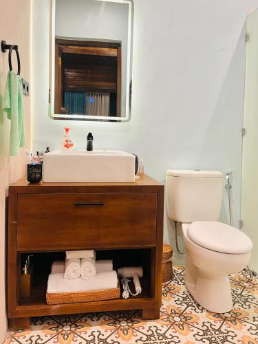 a bathroom with a sink and a toilet at Sun and Moon Bungalow Village in Uluwatu