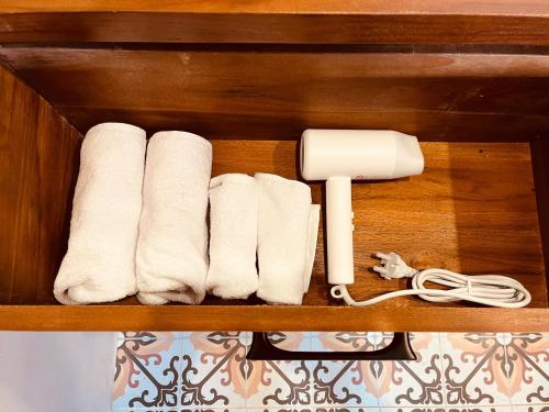 a group of rolled up toilet paper on a shelf at Sun and Moon Bungalow Village in Uluwatu