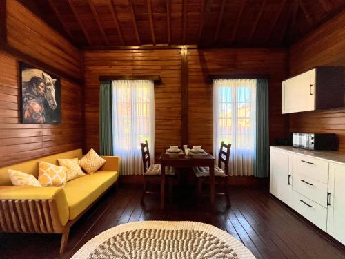 a living room with a yellow couch and a table at Sun and Moon Bungalow Village in Uluwatu
