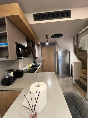 a kitchen with a counter top and a refrigerator at The Diamond In City Luxury Suites By ZENORA Living in Accra