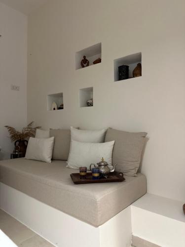 a couch with a tray on top of it at La casa nel verde klimt in Supersano