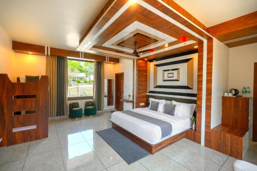 a bedroom with a large bed in a room at Appas Hotel in Bīr