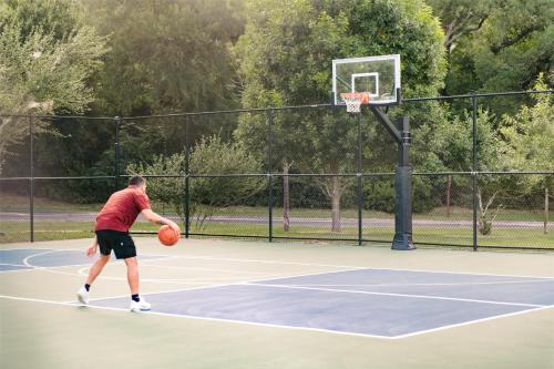 a man is playing basketball on a court at Hyatt Regency Lost Pines Resort and Spa in Cedar Creek