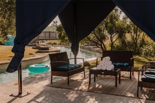 a group of chairs sitting next to a pool at Hyatt Regency Lost Pines Resort and Spa in Cedar Creek