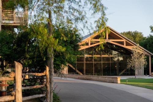 a wooden building with a fence in front of it at Hyatt Regency Lost Pines Resort and Spa in Cedar Creek