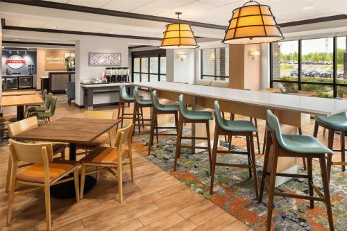 a bar with chairs and tables in a restaurant at Hampton Inn Minneapolis-Roseville,MN in Roseville