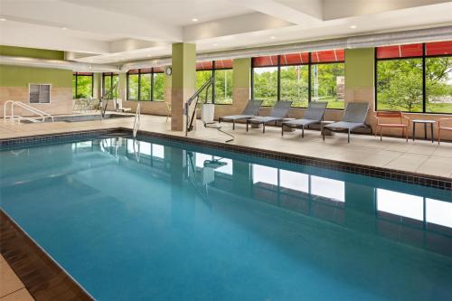 a large swimming pool with blue water in a building at Hampton Inn Minneapolis-Roseville,MN in Roseville