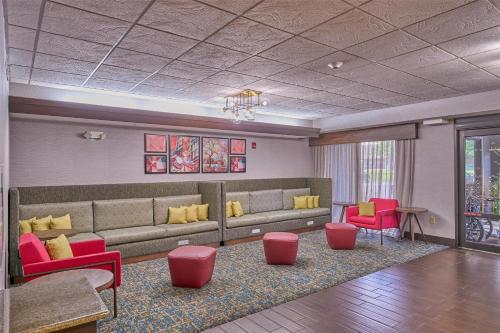 a waiting room with a couch and red chairs at Hampton Inn Flemington in Flemington