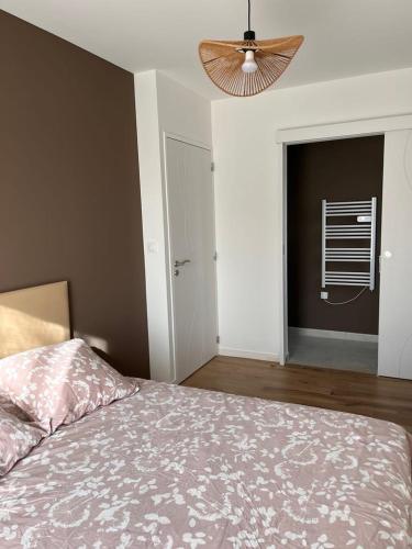 a bedroom with a bed and a window and a fan at Chambres d'hôtes avec piscine chauffée de mai à sept ,TERRA COTTA et TAUPE in Lanvollon