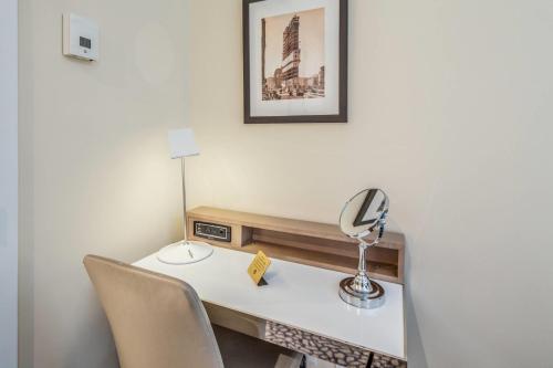a desk with two chairs and a lamp on it at The Historic Blue Angel Hotel Lexington Ave, an Ascend Collection in New York