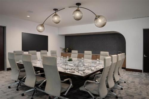 a conference room with a long table and chairs at Thompson Houston, by Hyatt in Houston