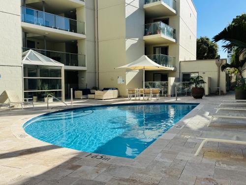 a swimming pool in front of a building at Beachside at Scarborough in Perth
