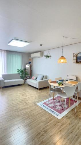 a living room with a table and a couch at Lake House in Hwaseong