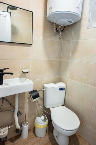a bathroom with a toilet and a sink at Albatross Breeze Bungalow 100m from the beach in Varna City
