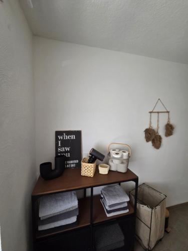 a shelf with towels on it in a room at TKS HOME Kroppacher Schweiz in Müschenbach