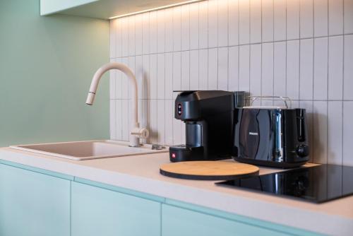 a coffeemaker sitting on a counter in a kitchen at Memphis Suites Kos Center in Kos Town