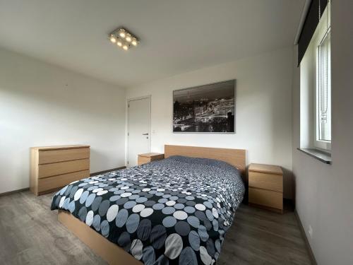a bedroom with a black and white bed and a window at Chambre à la campagne 