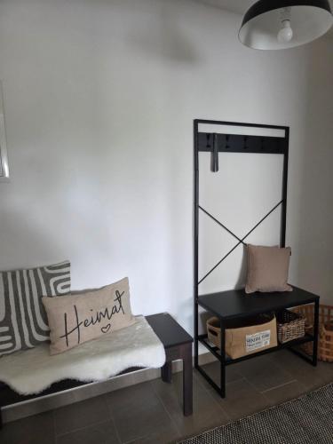 a living room with a couch and a table at TKS HOME Kroppacher Schweiz in Müschenbach