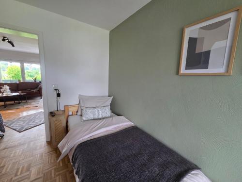 a bedroom with a bed and a picture on the wall at TKS HOME Kroppacher Schweiz in Müschenbach