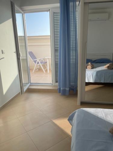 a bedroom with a bed and a view of the ocean at Apartment Lana Maris studio 2 - 200m from beach, terrace with sea view, wi-fi and free parking in Dramalj