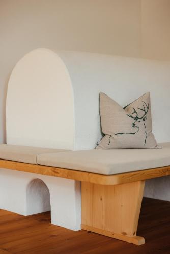 a bench with a pillow sitting on top of it at New Opening Penthouse Zirm in Selva dei Molini