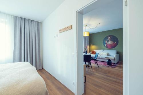 a bedroom with a bed and a living room at LeonArt Living 44 in Graz