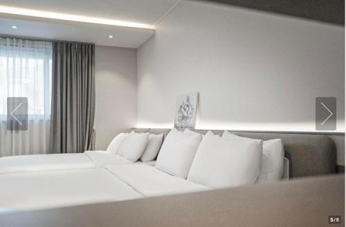a white couch in a room with a window at H Avenue Gyeongju Bulkuk temple in Gyeongju