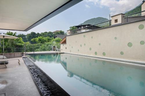 a swimming pool in a house with a wall at Seaberhof Kaltern in Caldaro