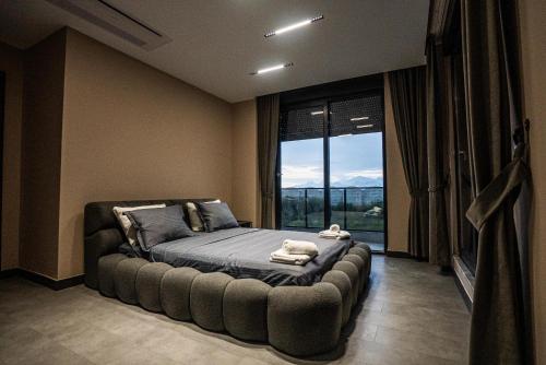 a bedroom with a bed with a large window at Belek Seven Luxury in Belek