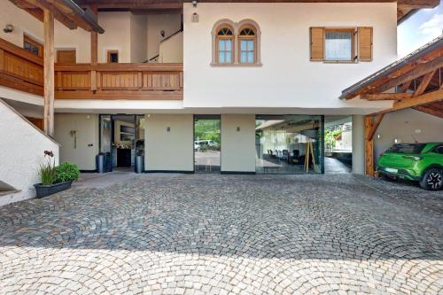 a house with a car parked in the driveway at Seaberhof Kaltern in Caldaro