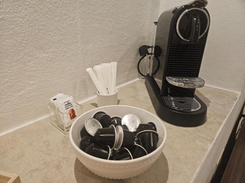 a white bowl of dishes on a counter next to a toaster at Joivy Dimore Rodiane - Ponente in Rodi Garganico