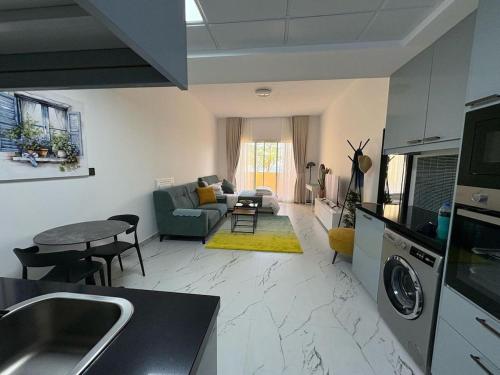 a kitchen and living room with a couch and a table at Studio at Bab Al Bahr RAK in Ras al Khaimah