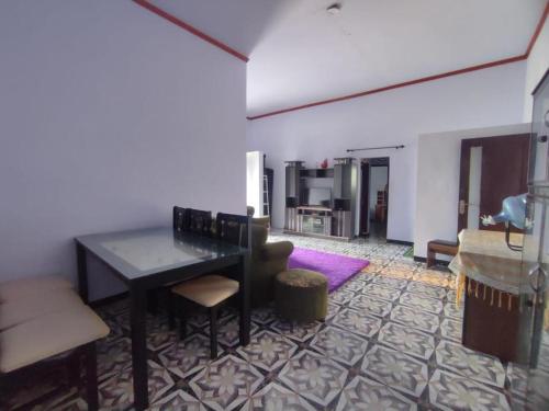 a living room with a table and a couch at Elen Villa by ABM in Ngadisari