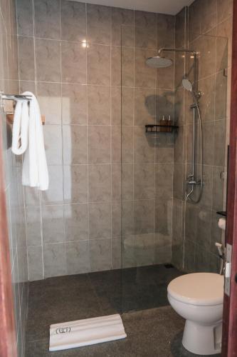 a bathroom with a glass shower with a toilet at Evara Lifestyle Villa by Aayan in Tabanan