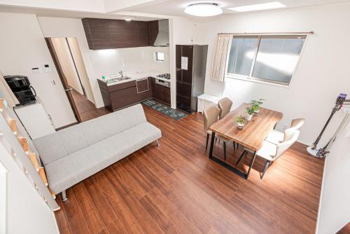 a living room with a couch and a table at 春明House in Tokyo