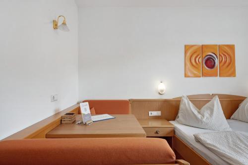 a small room with a bed and a desk with a bed sidx sidx sidx sidx at Seaberhof Kaltern in Caldaro