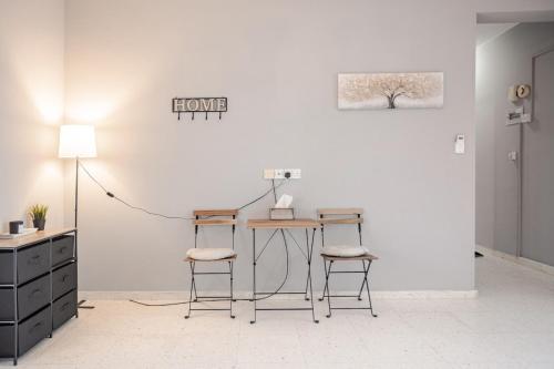 a room with a desk and two stools and a table at Sun Wave Villa Sea View Retreat in Peyia