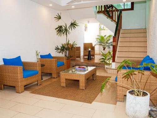 a lobby with wicker chairs and a coffee table at Boracay Beach Club in Boracay