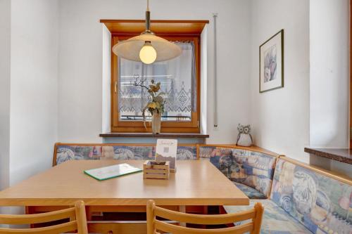 a dining room with a table and a couch at Seaberhof Kaltern in Caldaro