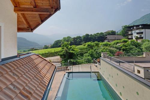 a swimming pool on the side of a building at Seaberhof Kaltern in Caldaro