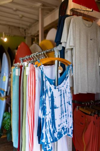 a closet filled with shirts and a rack of clothes at Surf Stay ITOSHIMA in Itoshima